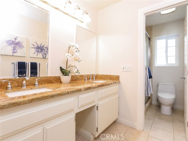 Master bath w/dual sinks, granite counters and tile flooring