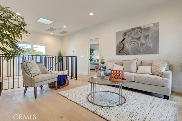 Upstairs family room with area with skylights, connecting two balconies, the master bedroom and two additional bedrooms, each with their own bathroom.