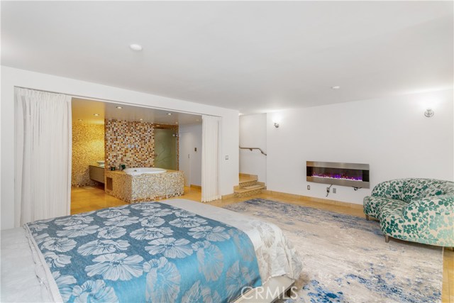 Luxurious bedroom with drapes open to dressing area