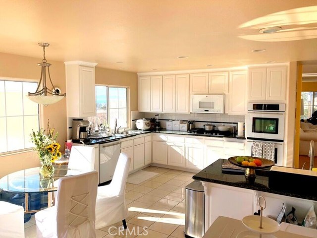 Nicely arranged kitchen, prep counter with sink.