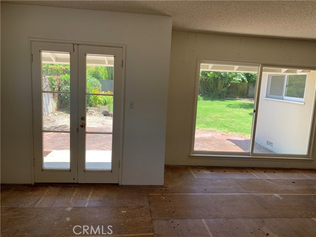 Living Room Area with View to Backyard Patio and Yard Area