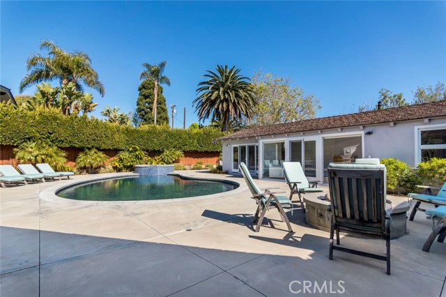 A resort of your very own - this gorgeous backyard offers a sparkling pool with spa, patios for lounging, outdoor dining area or courtyard and a fireplace as a focal point to create a stunning setting.