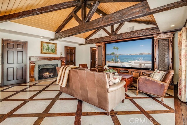 Guest house living room with huge projection screen and a fireplace.