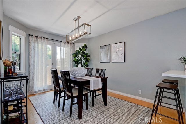 Spacious dining area with newer contemporary light fixture.