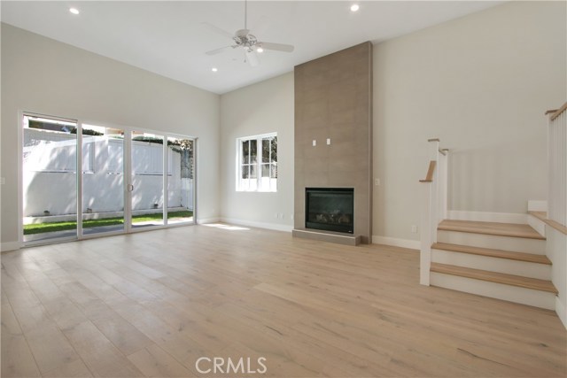 Wonderful living space with massive windows to the private back yard! 
Steps lead up to spacious dining room area!!