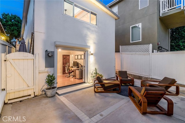 Rear patio with gas hookup for fire pit, looking into main house and 3rd bedroom.