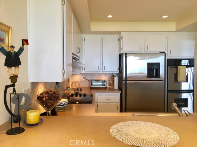 Inset lighting and underlighting. Tiled backsplash.