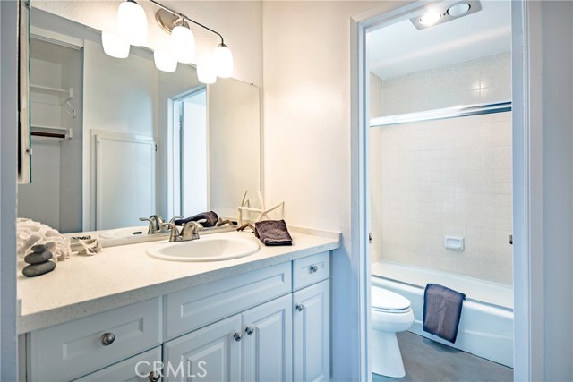 Master Bathroom with new cabinet, counter top, sink, light fixture, faucets and shower doors