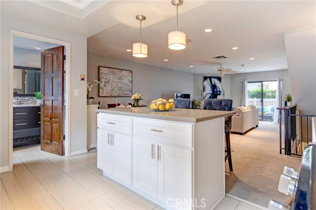 Fantastic open floor plan. Kitchen island with breakfast bar/counter. Main level powder room for guests. Living room opens to private outdoor patio. Fantastic open floor plan. Kitchen island with breakfast bar/counter. Main level powder room for guests. Living room opens to private outdoor patio.