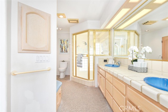 Master ensuite with dual sinks, stepdown custom tiled shower with waterfountain faucet to fill the soaking tub and or use as a Sauna with dual shower heads.