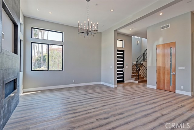 LIVING ROOM WITH FIREPLACE.  FROM THE DINING ROOM LOOKING AT THE FRONT DOOR