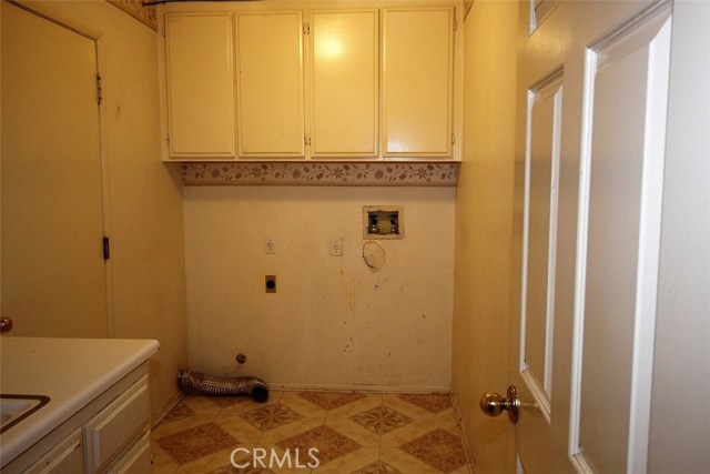 Interior laundry room. Built in cabinets and deep well basin