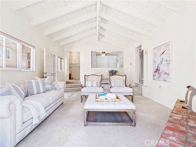 Family room, looking in toward the laundry area up the stairs on the left (off the kitchen-further to the left). Straight ahead, beyond the family room, is currently an open bedroom/office.  Stairs to the right is a hallway to bedrooms and bathrooms.