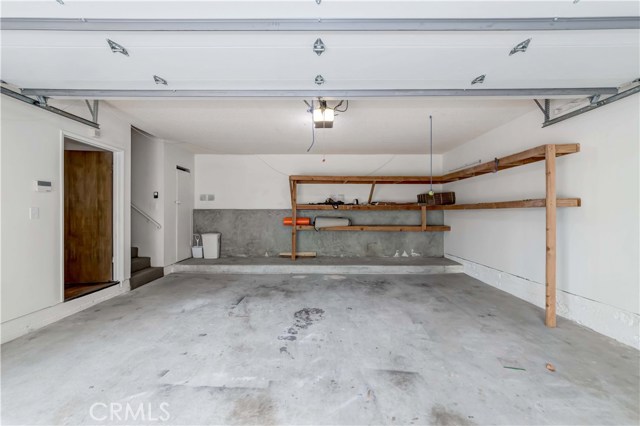 Spacious 2-car garage, shelving storage, laundry room off to the left