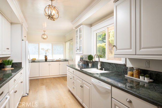 An updated kitchen to suit your culinary desires and opens and overlooks the courtyard patio.
