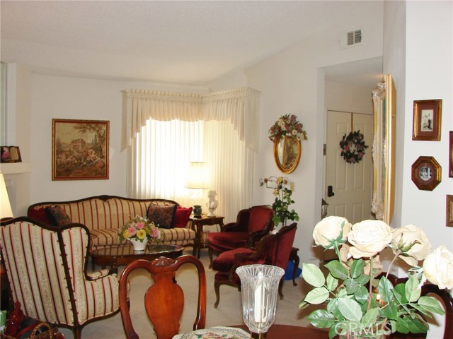 VIEW OF LIVING ROOM AND FRONT ENTRY. HIGH CEILINGS. PLENTY OF SPACE FOR VARIOUS FURNITURE PLACEMENT.