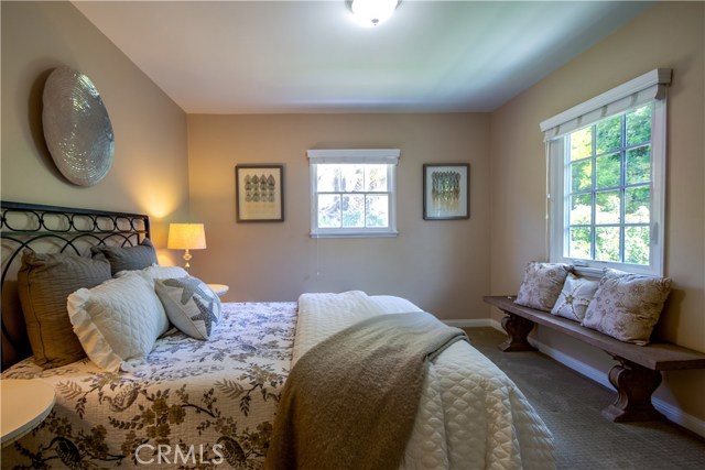 Bedroom overlooking verdant backyard