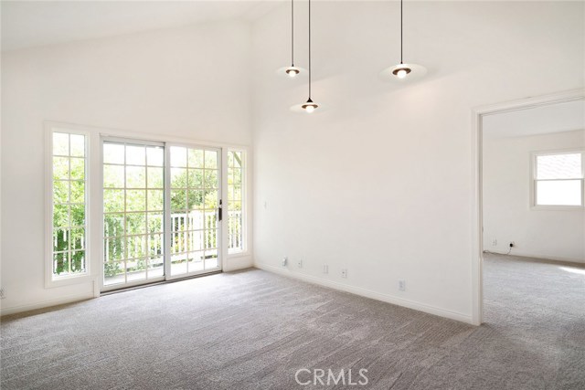 2nd level family room (yes, 2 family rooms in this home) and sliding doors lead to private sunny balcony. Note the vaulted ceilings. Master bedroom is at right. These 2 rooms are extremely sunny and bright.