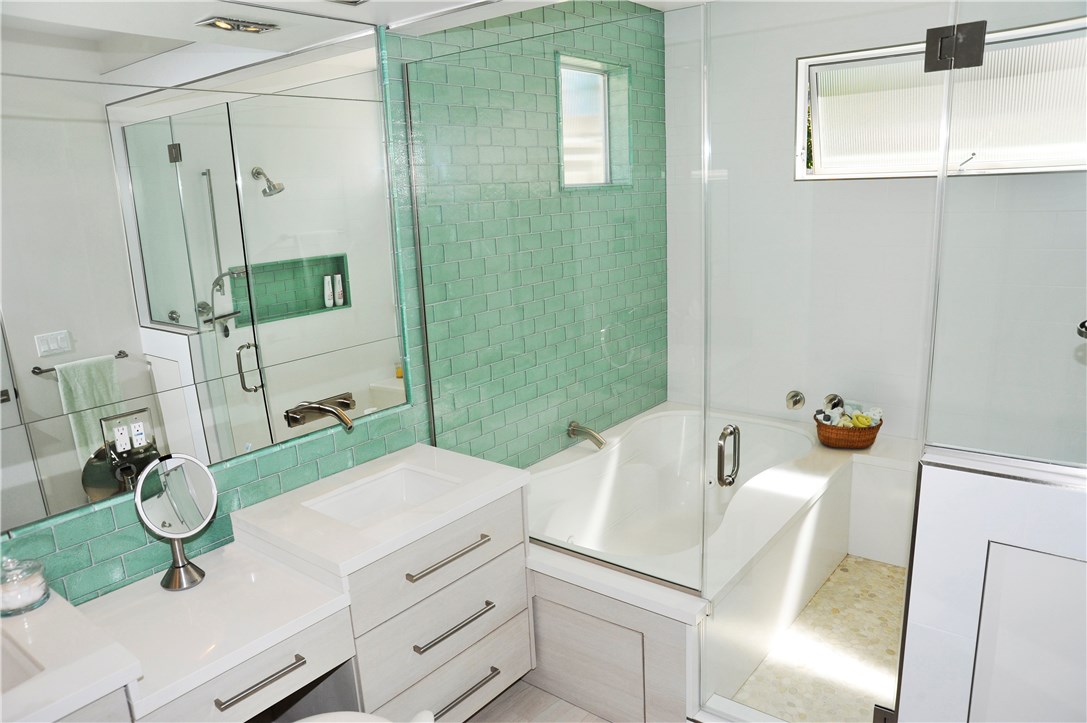 Master bath with soaking tub, walk in shower, quartz countertops, glass tiles, vanity