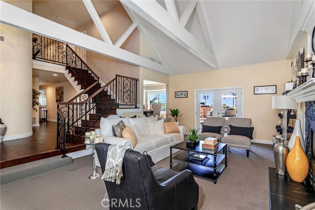 Updated Formal living room exits to the stunning backyard.