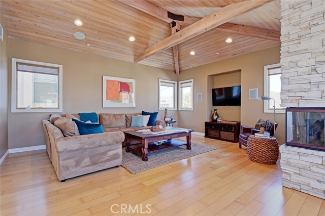 Spacious great room with vaulted ceilings, hardwood floors and fireplace.