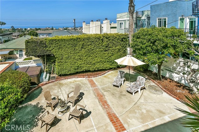 This view from the West windows looks down onto the very large rear yard which is surrounded by mature trees and lush landscaping, offering privacy as well as shelter on windy days.