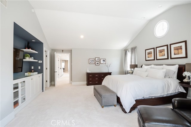 Master Bedroom features built-in cabinetry and vaulted ceilings