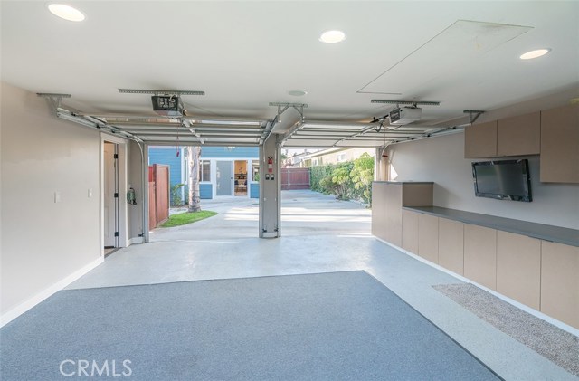 2 car garage with built in cabinets and counters.