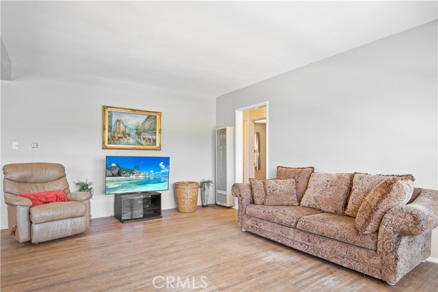 Entire house has original oak hardwood flooring. Living room is sunny and bright and quite large actually.