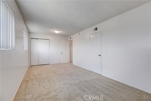 Here you can see the two entry doors to the room from the hallway on the right and the second closet in the back left corner