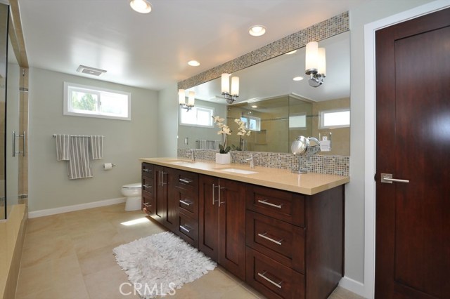 Double sinks and wall of mirrors add to the beauty of the Master Bath.