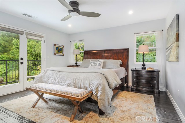 Master bedroom with balcony and lush views. Master bedroom with balcony and lush views.