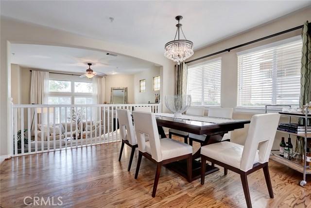 Formal dining area with arched ceilings and balcony overlooking the entry level great room.