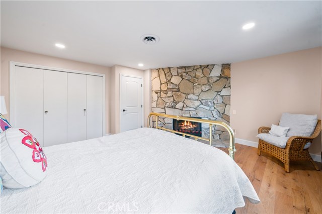 Downstairs bedroom with a PV stone fireplace.