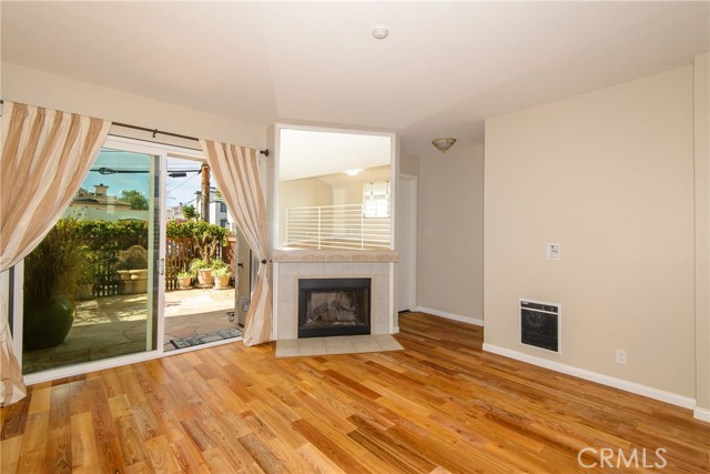Living room with Teak wood flooring looking out to the private patio! Living room with Teak wood flooring looking out to the private patio!