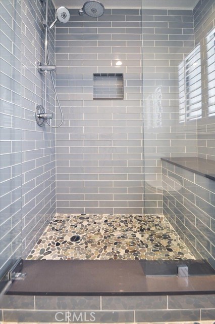 Close up view of the Master Shower with its glass tile, stone & granite. Grohe rainshowers, built-in bench for complete relaxation!