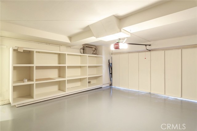 garage with built in shelves, new garage door opening system and new epoxy floors