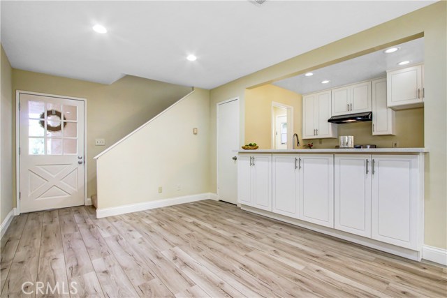 Living area open wide up to kitchen.  Quartz counters can be used to eat in bar area.  Lots of new cabinets below.