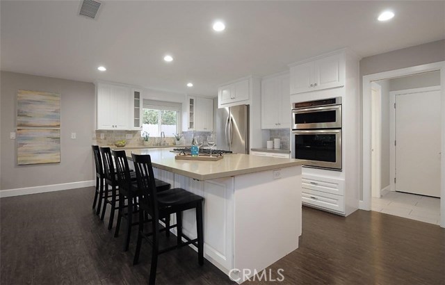 Open concept kitchen with high end appliances and large walk-in pantry