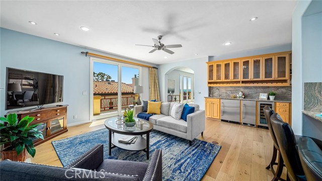 Family room with better view of wet bar with refrigerator and wine cooler.