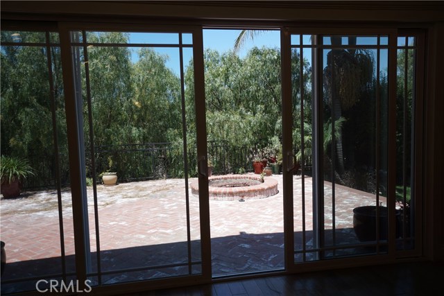 Great room looks out to patio with fire pit and spa