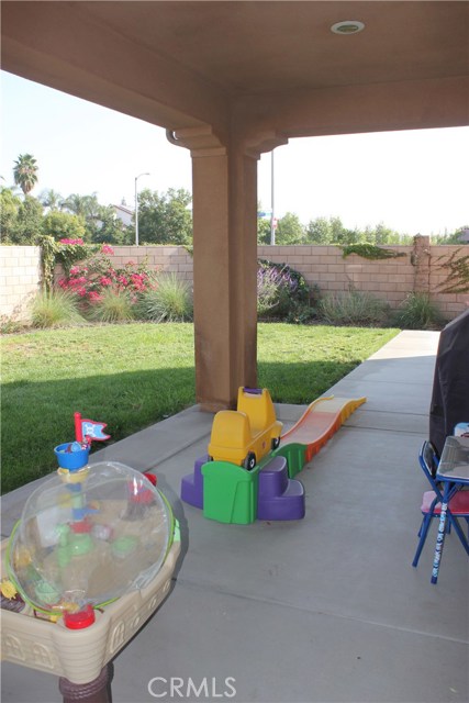 Covered patio area has generous space for entertainment.