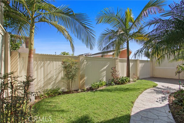 COZY BACK YARD WITH GRASS, PALM TREES & ROSE BUSHES