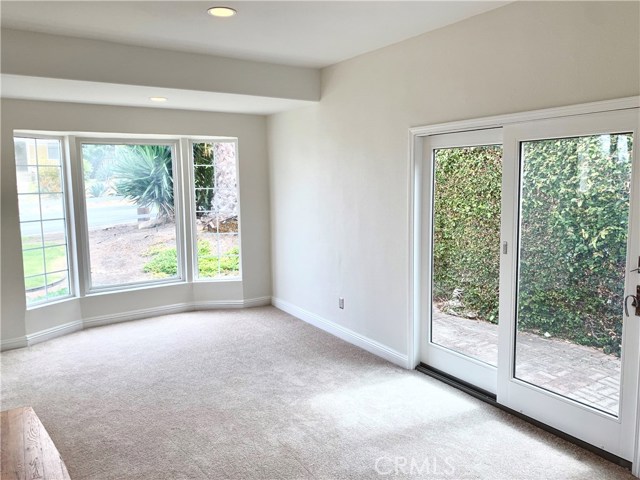 Step-down den, can easily be converted to a master bedroom. New carpet. New paint throughout. Slider to private side yard sitting area, and bay window.