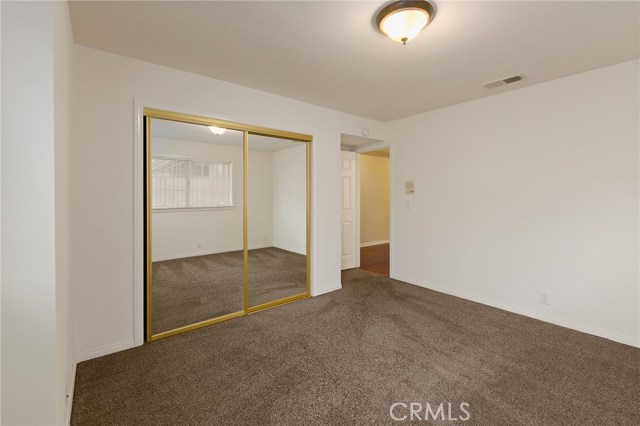Front downstairs bedroom with Wardrobe closet doors and ceder lined closet.