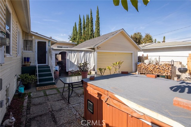 Back door with garage,  spa and an area that is attached between garage and home that can be used for storage, etc.