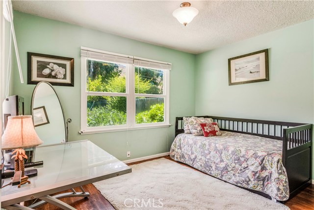 Bedroom #2 also features hardwood flooring and natural light throughout