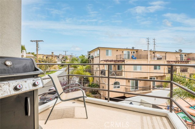 Balcony off the kitchen overlooks the adjacent swimming pool.