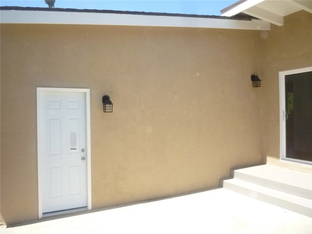 Walk-through door from the two car attached garage to the side yard patio.