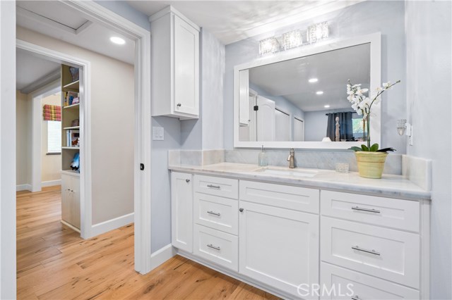 Master bedroom bath marble vanity with crystal light fixture.